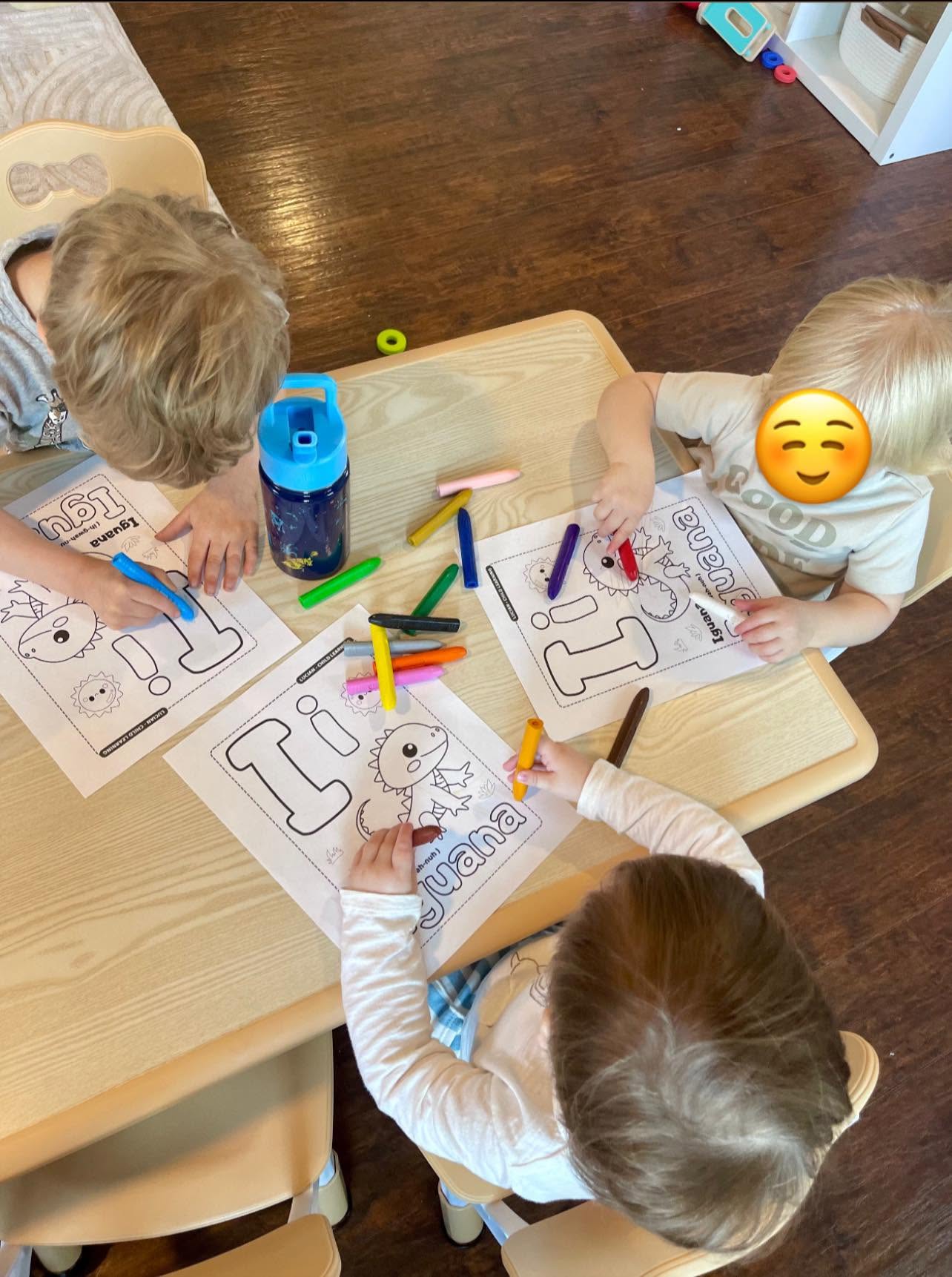 Children coloring a letter I for iguana worksheet